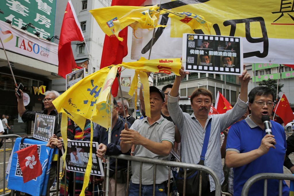 Hong Kong China Tiananmen Anniversary Pro-Beijing supporters destroy yellow umbrellas, used to mark protesting denouncing far-reaching Beijing control, during a demonstration in Hong Kong, Sunday, May 26, 2019. A vigil will be held on June 4 at the Victoria Park to mark the 30th anniversary of the military crackdown on the pro-democracy movement at Beijing's Tiananmen Square on June 4, 1989. (Kin Cheung/AP Photo)
