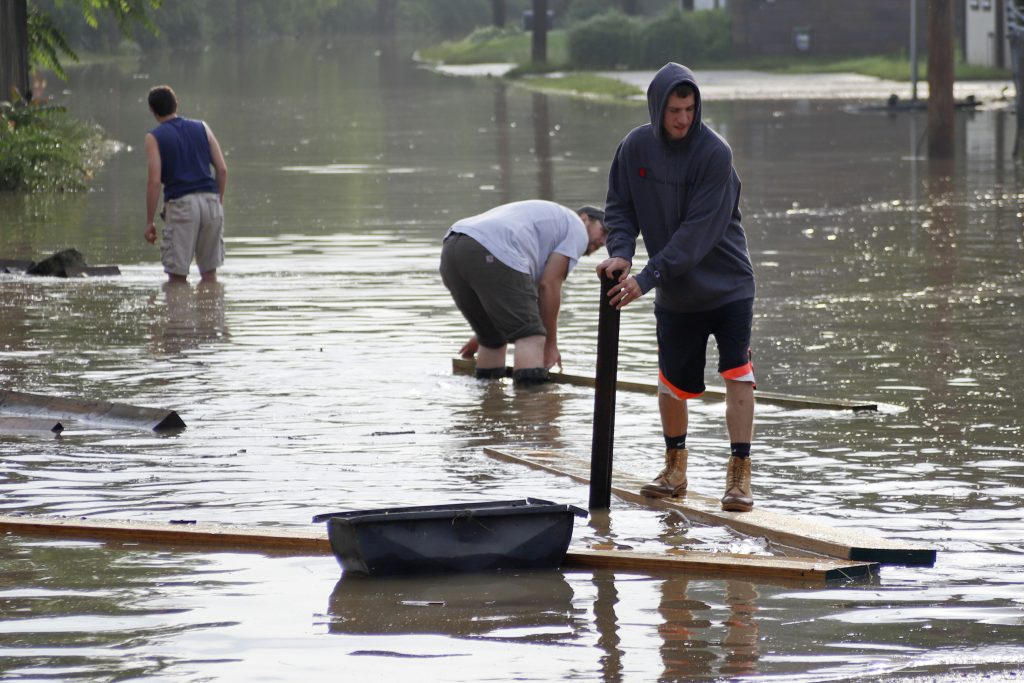 Severe Weather Pennsylvania Workers wade through floodwaters to recover lumber that floated from a lumber yard, Wednesday, May 29, 2019, in Harmony, Pa. More storms are predicted for the area. (AP Photo/Keith Srakocic)