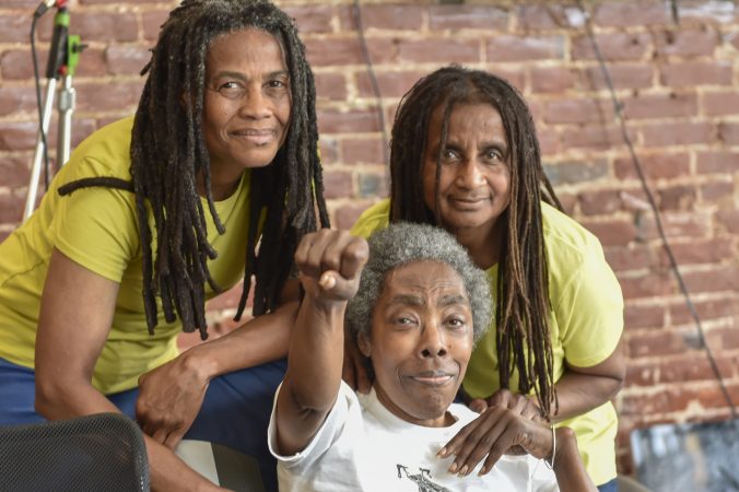 (From left) Janine Africa, Ramona Africa, and Janet Africa pose for a photo at the MOVE press conference. (Jonathan Wilson for WHYY)