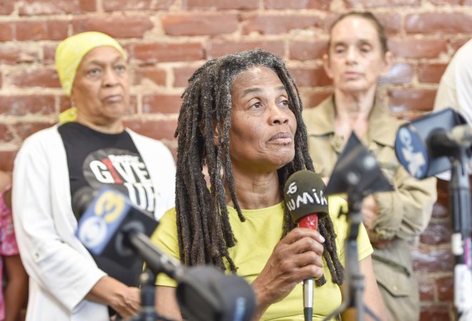 Janine Africa listens to a question during the press conference. Behind her are Pam Africa (left) and Sue Africa (right). (Jonathan Wilson for WHYY)