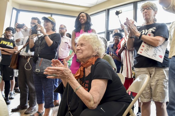 Suzanne Ross applauds Janine Africa's reponse to a question. (Jonathan Wilson for WHYY)