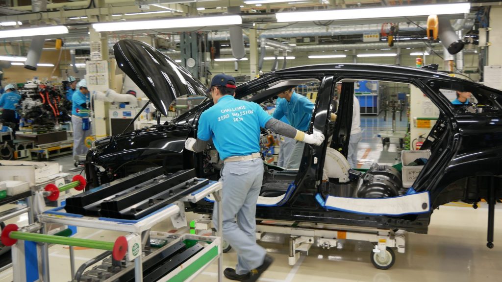 P1240880-1920×1080 Workers push a partly assembled Mirai through the assembly line at Toyota's LFA Works in Aichi Prefecture, Japan. Since there are so few hydrogen fuel cell cars manufactured, all of them are assembled by hand. (Hiroo Saso)