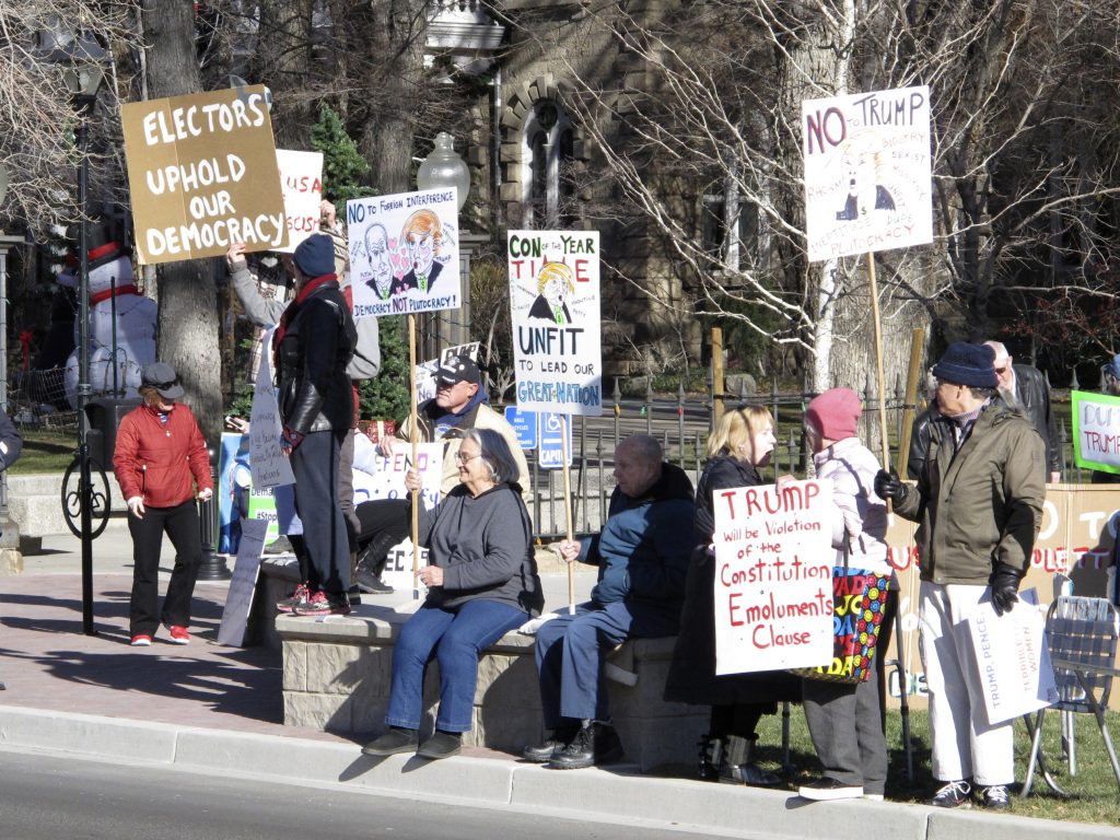 Protesters demonstrate against then President-elect Donald Trump outside the State Capitol building in Carson City, Nev., in December 2016 while Nevada's six Democratic presidential electors inside cast their official Electoral College ballots for Hillary Clinton.
(Scott Sonner/AP)
