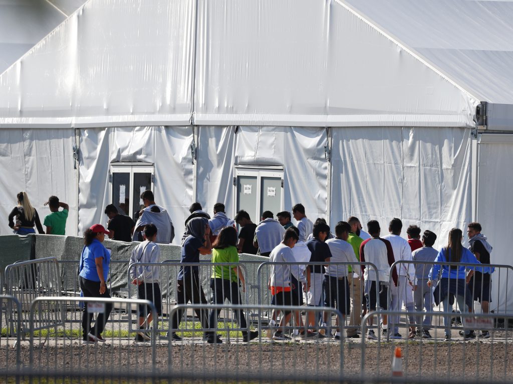 Children line up to enter a tent at the Homestead Temporary Shelter for Unaccompanied Children in Homestead, Fla., in February. Children line up to enter a tent at the Homestead Temporary Shelter for Unaccompanied Children in Homestead, Fla., in February. (Wilfredo Lee/AP)