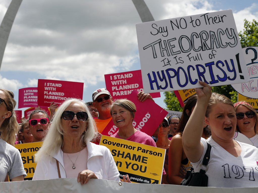 Abortion-rights supporters take part in a protest in St. Louis.The Planned Parenthood clinic in the area will stay open while its legal fight with the state continues. Abortion-rights supporters take part in a protest in St. Louis. A St. Louis judge heard an hour of arguments Thursday on Planned Parenthood's request for a temporary restraining order that would prohibit the state from allowing the license for Missouri's only abortion clinic to lapse at midnight Friday. (Jeff Roberson/AP Photo)