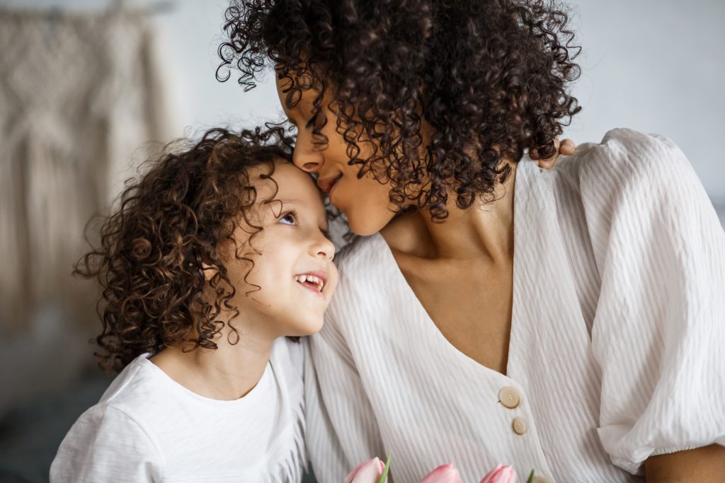 Happy Mother’s Day, Daughter Gives A Bouquet Of Tulips. African-american Girl With A Smile Without T Mothers bring life to a world where death too often holds sway. They
bring authenticity to a world where relationships are often fake. (lastudio87/Big Stock)