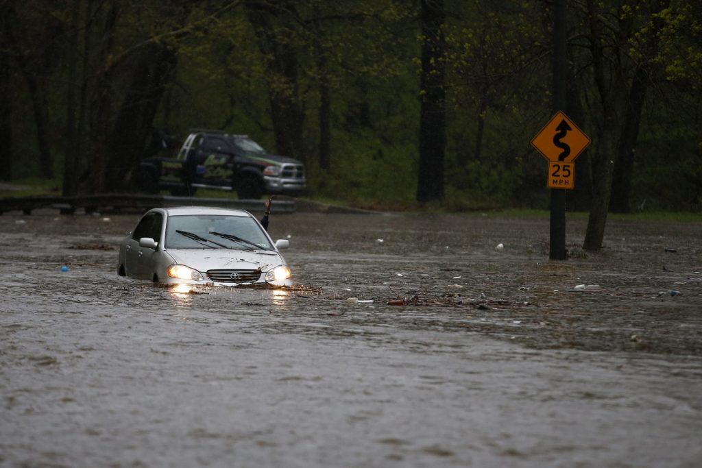 floods-cobbs-creek-1920×1280 A man waves for a tow truck after getting swamped trying to cross a flooded section of the Cobbs Creek Parkway, Wednesday, April 30, 2014, in Philadelphia. Cobbs Creek and Darby Creek merge in the Eastwick section of Philadelphia where flooding is expected to get worse due to rising sea levels. (AP Photo)