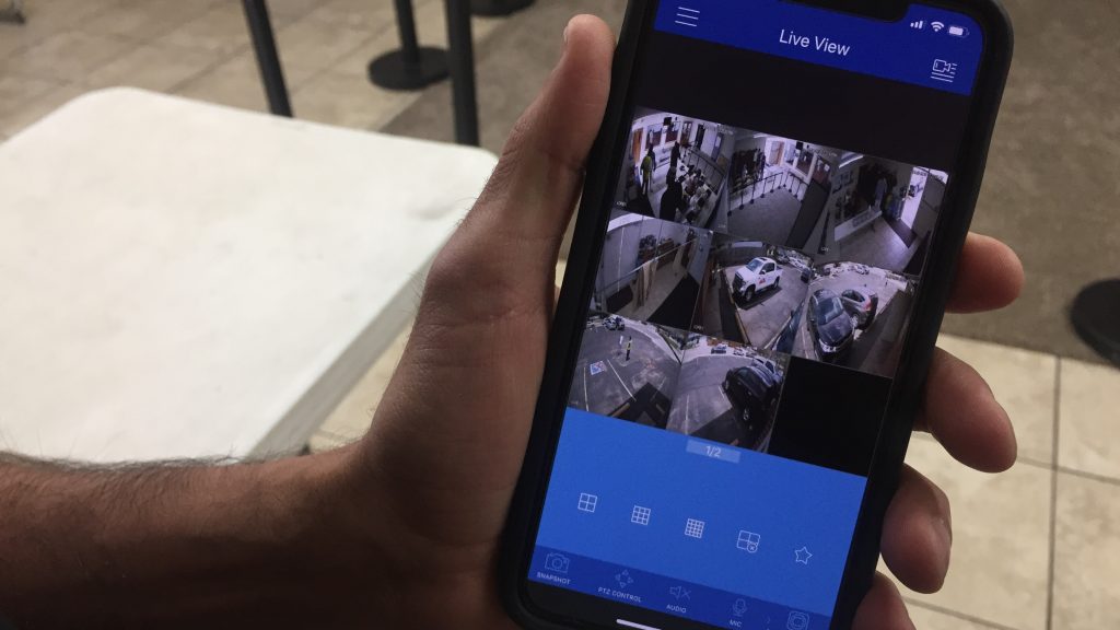 Kamel Elwazeir looks at a surveillance app on his phone. “It’s truly sickening but it’s part of our life,” Elwazeir says of having to implement security measures at his mosque. “It’s part of our society that we have to be prepared in case of an emergency.” Kamel Elwazeir looks at a surveillance app on his phone.