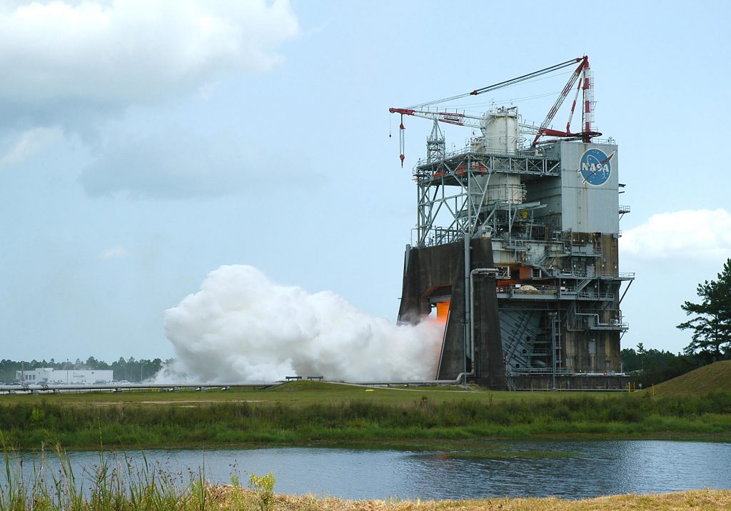 NASA conducts a successful hot fire test a rocket engine at the Stennis Space Center in Mississippi. Casey Dreier says NASA built it here partly because a senator from Mississippi was on the 1960s Senate appropriations committee. (Photo credit: NASA/SSC)