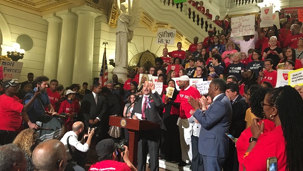 Philly Democrat Chris Rabb, who is sponsoring a bill to shift entirely to the Fair Funding formula, speaks at a rally. (Katie Meyer/WITF)