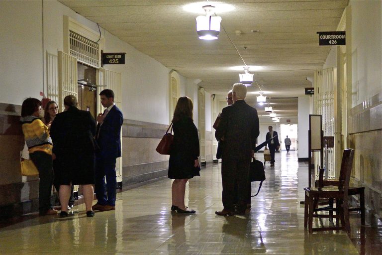 Lawyers gather in the hallway at Philadelphia City Hall that houses the First Judicial District of Pennsylvania. A computer virus has shut down the court's website. (Bastiaan Slabbers for WHYY)