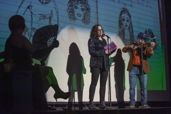 Kitty Smitty performs a satirical reading from her diary while a fiddler plays Ashokan Farewell. (Jonathan Wilson for WHYY)