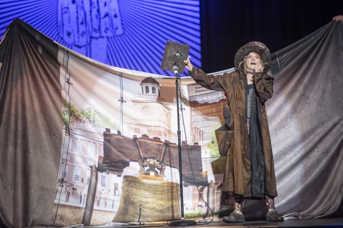 VertigoPlanes artist Mauri Walton holds the Book of Spells aloft. (Jonathan Wilson for WHYY)
