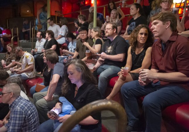 Audience members wait in the balcony for the show to begin. (Jonathan Wilson for WHYY)