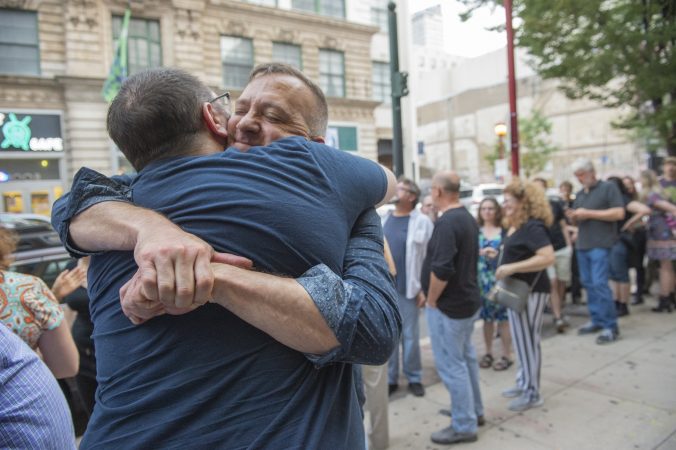 Big Mess Cabaret aficionados Pen Audley (left) and Everett Wilde greet each other in line while waiting for the final performance at the Troc. (Jonathan Wilson for WHYY)
