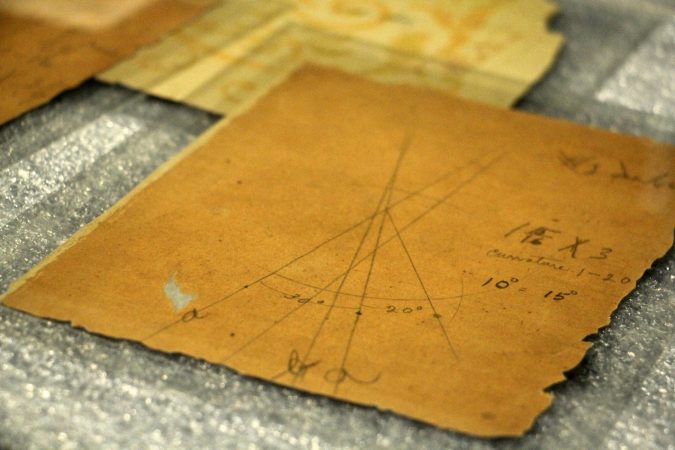 The Franklin Institute collection includes scraps of wallpaper on which the Wright Brothers made calculations and diagrams as they worked on their flying machine. (Emma Lee/WHYY)