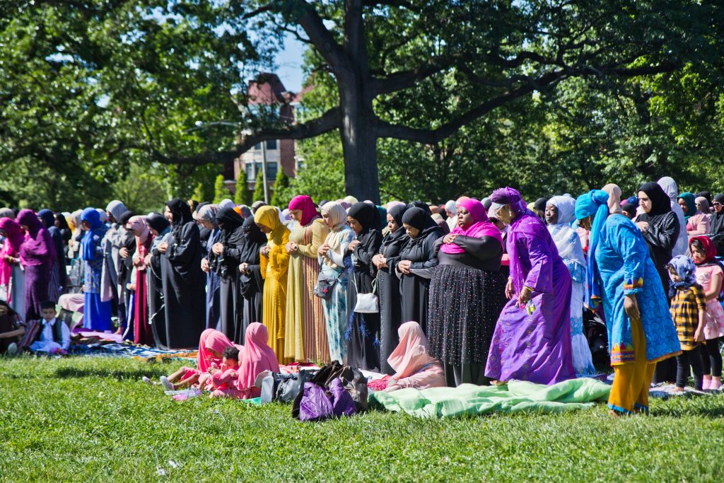 Members of the Muslim community pray at the end of Ramadan festival Eid al-Fitr in Fairmount Park. (Kimberly Paynter/WHYY)