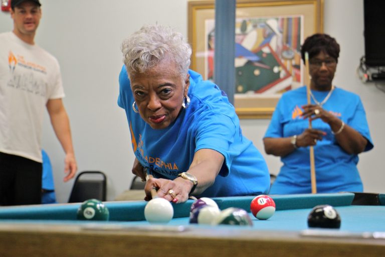 Mary Morris, 76, lines up her shot during the the Philadelphia Senior Games at West Oak Lane Senior Center. Morris, who has been playing pool since she was 12 years old, won her round against Pat Gathers, 77 (right)