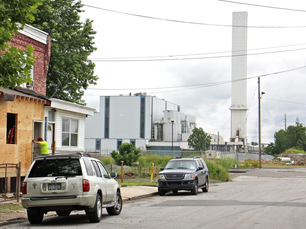 2019 06 13-e lee-chester-delaware valley resource recovery facility incinerator The smokestack of the Delaware Valley Resource Recovery Facility looms over a residential street in Chester. (Emma Lee/WHYY)