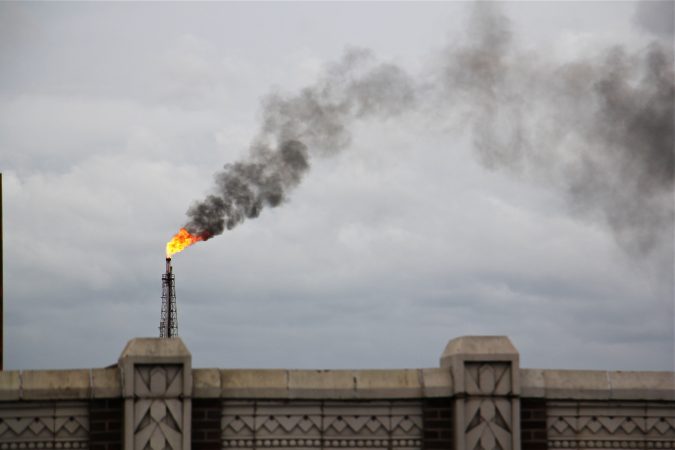 A large flare burns off fuel at Philadelphia Energy Solutions refinery while firefighters battle a fire there. (Emma lee/WHYY)