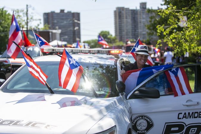Belinda Villegas Ramos from Camden Metro Police participates in the San Juan Bautista parade. (Miguel Martinez/WHYY)