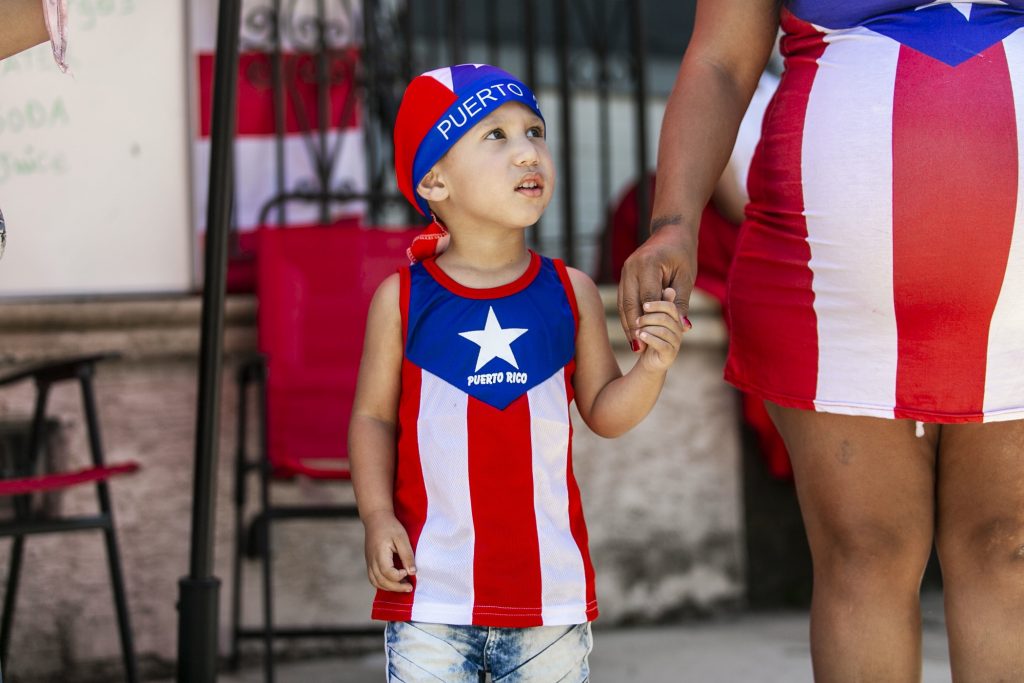 2019 06 23-m martinez-camden-puerto rico parade Jashua Vargas from Camden takes part in the San Juan Bautista Parade and Festival on the Camden waterfront. The parade has been a tradition in the city for the 62 years. (Miguel Martinez/WHYY)