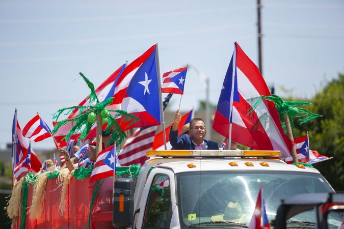 Camden City Councilman Angel Fuentes greets the crowd at the San Juan Bautista Parade and Festival. (Miguel Martinez/WHYY)