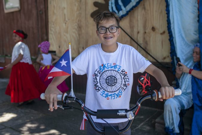 Angel  Soldevilla, 13, from Camden rides his decorated bike to celebrate the San Juan Bautista Parade and Festival. (Miguel Martinez/WHYY)