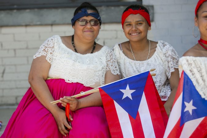 Karinairy Delgado and her mother Ivira Santiago attend the San Juan Bautista Parade and Festival. (Miguel Martinez/WHYY)