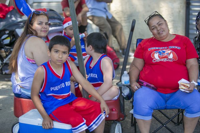 The Rodriguez family from Camden attend the San Juan Bautista Parade and Festival.  (Miguel Martinez/WHYY)