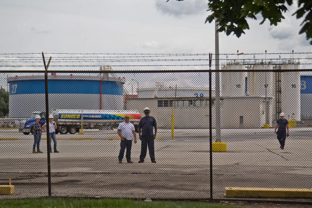 2019 06 25 k paynter refinery protest-8 Refinery works watch protestors outside the PES refinery Tuesday. (Kimberly Paynter/WHYY)