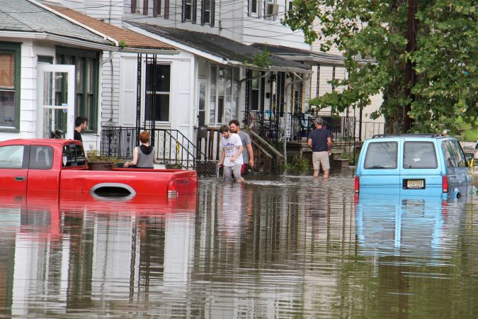 File photo: Residents of High Street in Westville, N.J., return to their homes as flood waters begin to recede on June 20, 2019. (Emma Lee/WHYY)