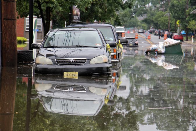Cars, homes and streets in low lying areas of Westville, N.J. were swamped by heavy rains overnight. (Emma Lee/WHYY)