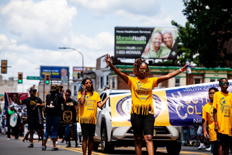 The Juneteenth Parade makes its way down 52nd Street in West Philadelphia Saturday where it was being held for the first year after moving from Center City Philadelphia. (Brad Larrison for WHYY)