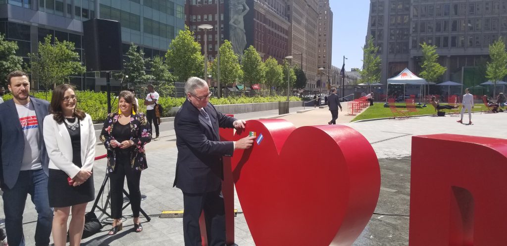 20190604_102106 Mayor Jim Kenney puts his flag of family origin on the new sculpture at Love Park. (Tom MacDonald/WHYY)