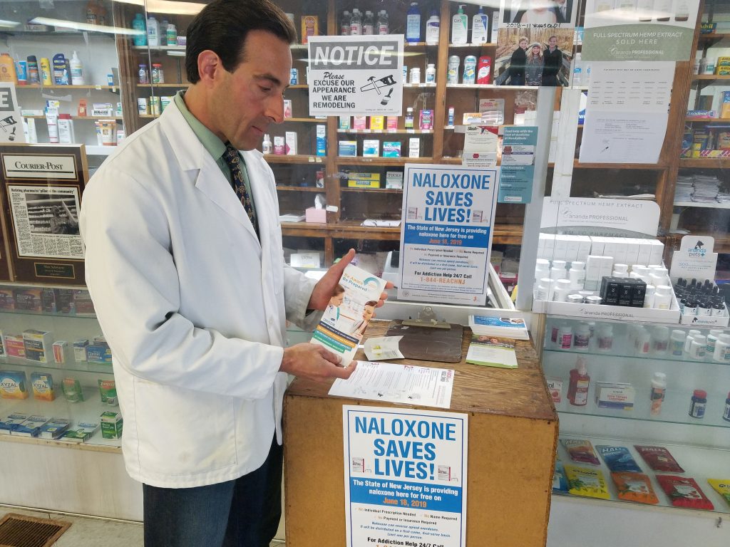 20190618_123056 File photo: Anthony Minniti, a pharmacist and the owner of Bell Pharmacy in Camden, displays some of the educational material he handed out to people claiming free doses of naloxone on Tuesday, June 18, 2019. (Nicholas Pugliese/WHYY)