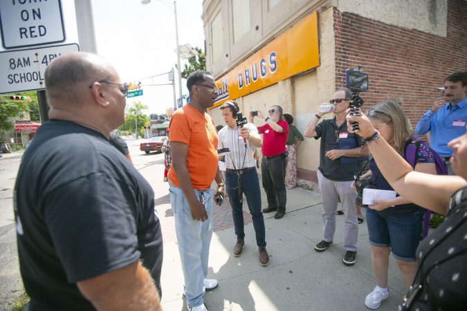 Camden business owner Todd Israel speaks about his experience owning a business in Camden during a group tour of the city (Miguel Martinez for WHYY)