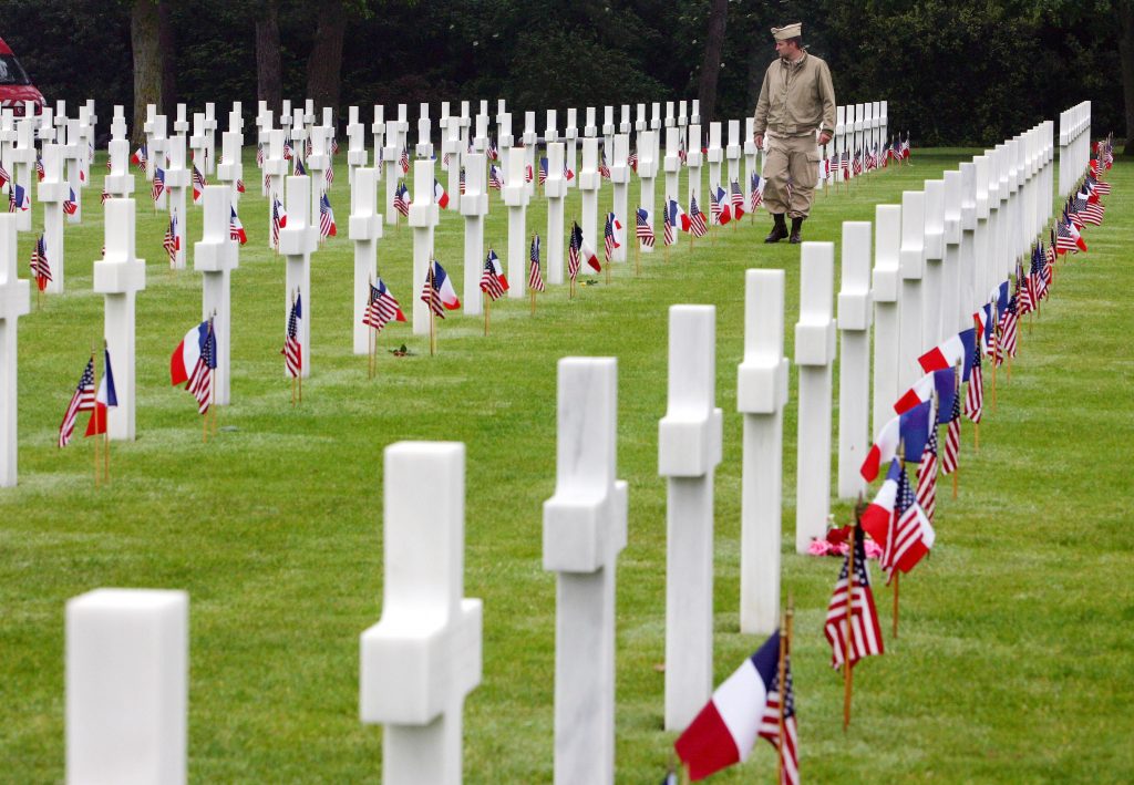 Robert M. Gates, Craig R. Stapleton, Walter Ehlers A visitor wearing a U.S. military uniform walks past graves at the American cemetary, in Colleville-sur-Mer, western France, in this June 6, 2007 file photo. (Remy de la Mauviniere/AP Photo)