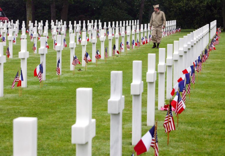 A visitor wearing a U.S. military uniform walks past graves at the American cemetary, in Colleville-sur-Mer, western France, in this June 6, 2007 file photo. (Remy de la Mauviniere/AP Photo)