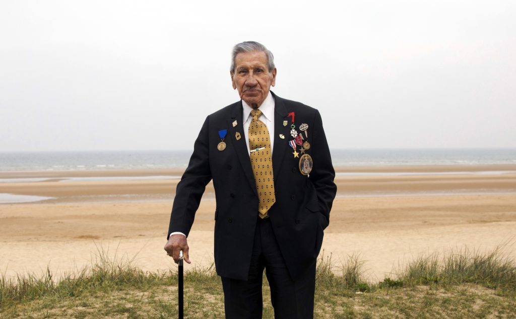 D Day 75 Years Later World War II and D-Day veteran Charles Norman Shay, from Indian Island, Maine, poses on a dune at Omaha Beach in Saint-Laurent-sur-Mer, Normandy, France, Wednesday, May 1, 2019. Shay was a combat medic on D-Day, assigned to an assault battalion in the first wave of attacks on D-Day, June 6, 1944. (Virginia Mayo/AP Photo)