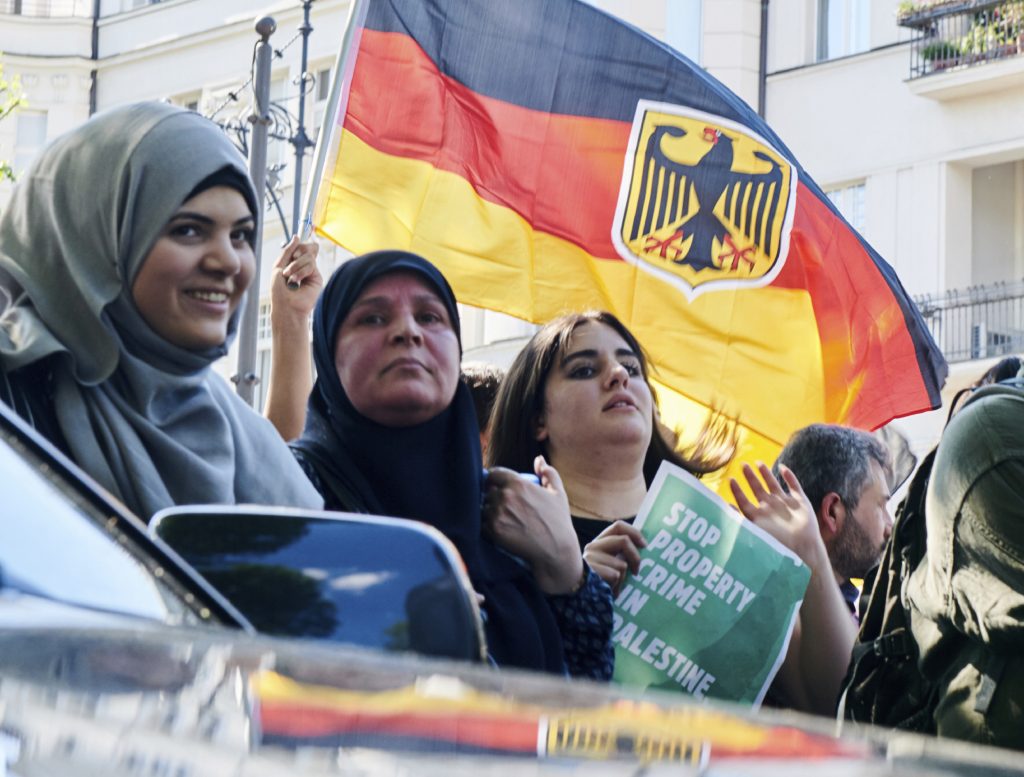 Germany Israel Protests Participants wave a German flag during an anti-Israeli al-Quds demonstration in Berlin, Germany Saturday June 1, 2019, on al-Quds Day at the end of Ramadan, the Muslim month of fasting. The annual al-Quds, Arabic for Jerusalem, march against Israel drew more than 1,000 participants, with some chanting “Palestine will be reborn!” or “Free Gaza!”. (Annette Riedl / dpa via AP)