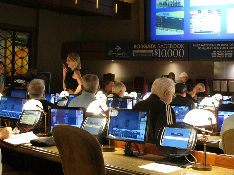 This June 14, 2018 file photo shows bettors waiting to make wagers on sporting events at the Borgata casino in Atlantic City hours after it began accepting sports bets. On May 22, 2019, the Borgata announced it will spend $12 million on a new sports betting bar and lounge project. (Wayne Parry/AP Photo)