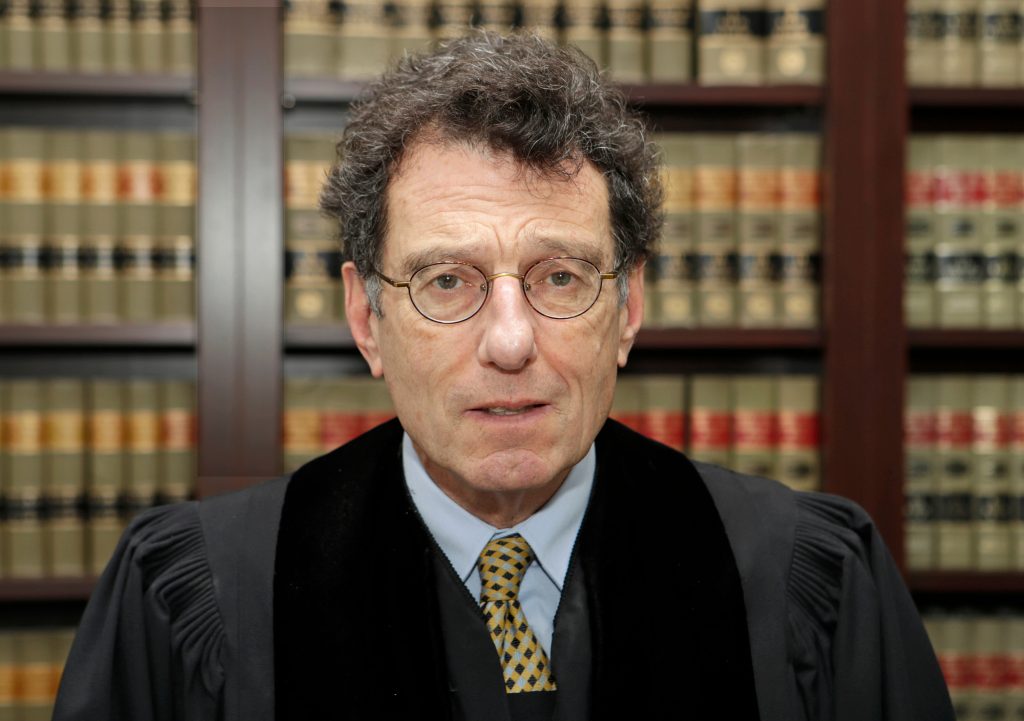 Dan Polster In this Jan. 11, 2018, file photo, U.S. District Judge Dan Polster poses for a portrait in his office in Cleveland. Polster is holding a hearing Tuesday, June 25, 2019, in Cleveland on a plan pitched by lawyers for local governments on distributing money to nearly 25,000 municipal and county governments. The plan would take effect if companies that make and distribute the powerful prescription painkillers agree to one or more legal settlements. (Tony Dejak/AP Photo)