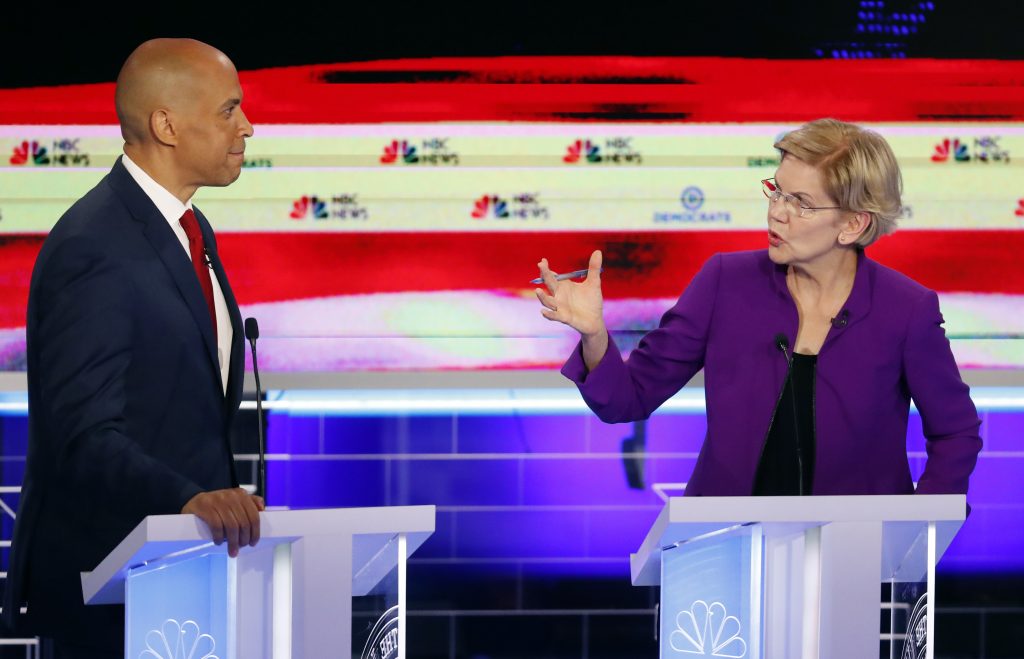 APTOPIX Election 2020 Debate Democratic presidential candidate Sen. Elizabeth Warren, D-Mass., gestures towards New Jersey Sen. Cory Booker, during a Democratic primary debate hosted by NBC News at the Adrienne Arsht Center for the Performing Arts, Wednesday, June 26, 2019, in Miami. (Wilfredo Lee/AP Photo)