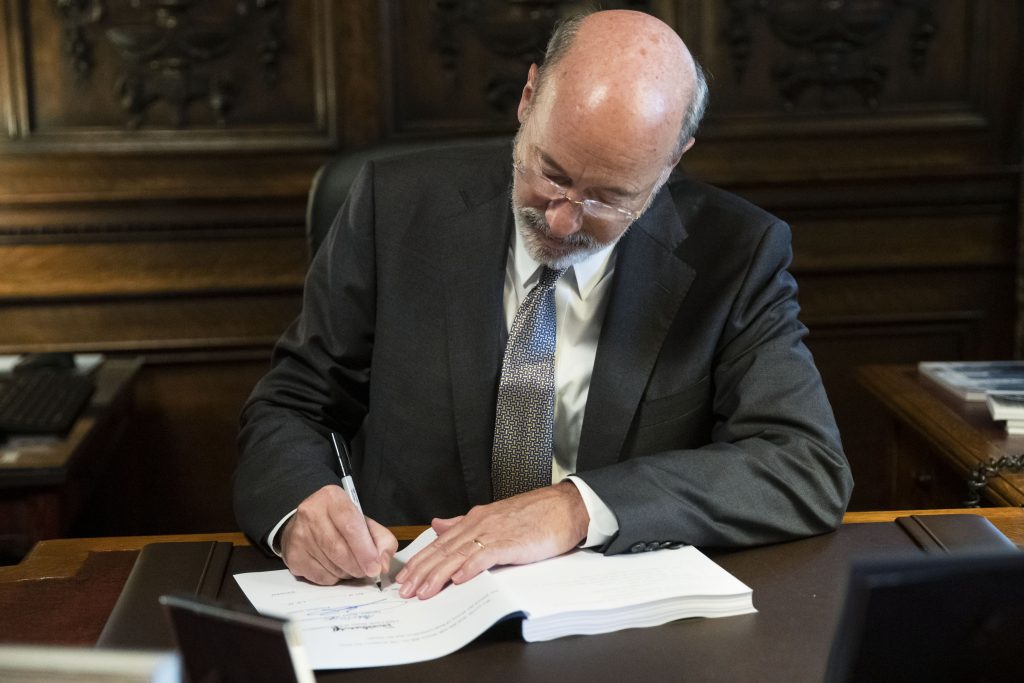 Tom Wolf Pennsylvania Gov. Tom Wolf signs the main appropriations bill in a $34 billion budget package that passed the Legislature this week at the state Capitol in Harrisburg, Pa., Friday, June 28, 2019. (Matt Rourke/AP Photo)