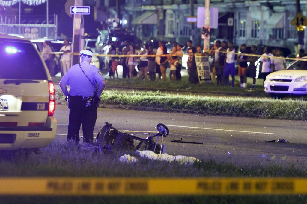 Family Struck on Highway A police officer stands by a sheet covering the remains of a young child and a baby stroller at the scene of a fatal accident on Roosevelt Boulevard in the Olney section of Philadelphia on Tuesday July 16, 2013. (Joseph Kaczmarek/AP Photo)