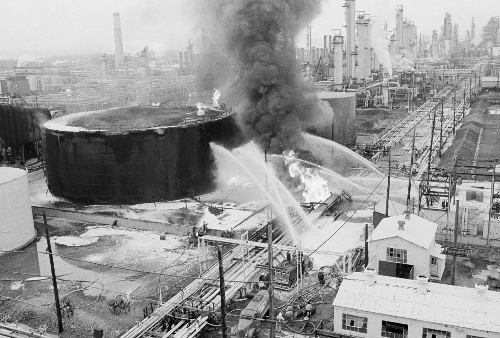 Oil Disasters Fireman direct water at a crude oil storage tank and oil lines that exploded at the Gulf Oil Refinery in Philadelphia, Sunday, August 17, 1975. Main route and bridge over the refinery were closed to the Philadelphia international airport. (Rusty Kennedy/AP Photo)