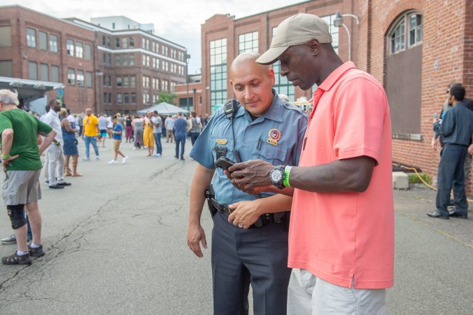 Army Sergeant Cedrick Ghant-David struck up a conversation with Trenton Police detective Sammy Gonzalez. Gonzalez was one or the detectives who processed the shooting scene at last year's Art All Night event. (Jonathan Wilson for WHYY)