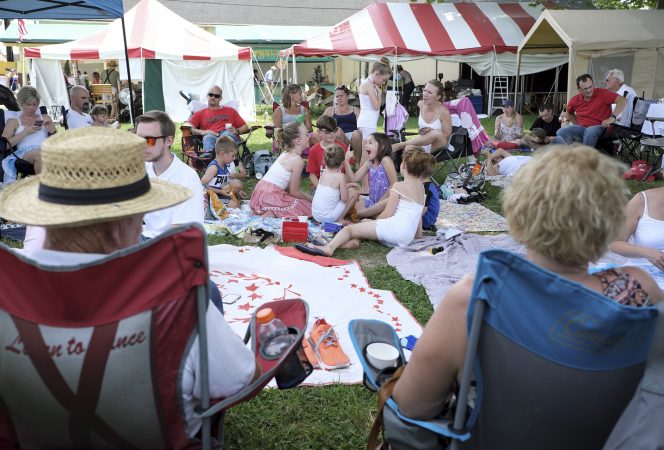 Members of the Miller Family rest between performances of the Miller Family Hoedown on July 1, 2018, during the Kutztown Folk Festival in Kutztown, Pennsylvania. (Matt Smith for WHYY)