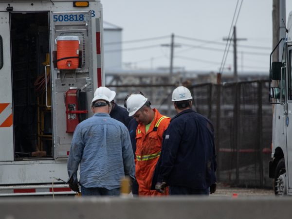 Philadelphia Gas Works employees gathered at the Energy Solutions Refining Complex after an explosion on Friday, June 21. (Angela Gervasi for WHYY)